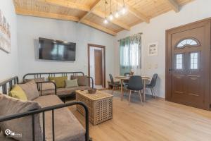 a living room with a couch and a table at Myrtali's Guesthouse Ιn Tzoumerka 