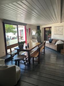 a living room with a table and a couch at chambre d hôtes les trois châteaux in Notre-Dame-de-Riez +9 photos