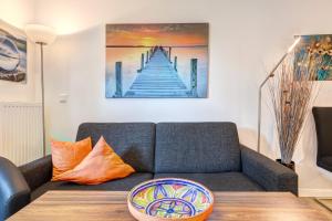 a living room with a couch and a table at Residenz am Balmer See - BS 10 mit Wellnessbereich in Balm