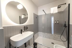 a bathroom with a sink and a mirror at Montebello Comfort in Ancona +24 photos