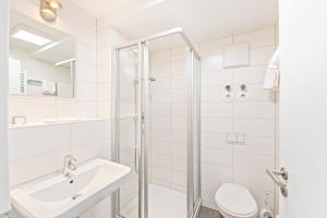 łazienka z prysznicem, umywalką i toaletą w obiekcie Meri Boarding Europaplatz w Stuttgarcie +14 zdjęć