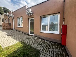 a row of houses with windows on the side at Apartmán MINOR in Slavkov pod Hostýnem
