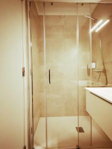a shower with a glass door in a bathroom at CASAS DA RUA NOVA in Alijó +11 photos