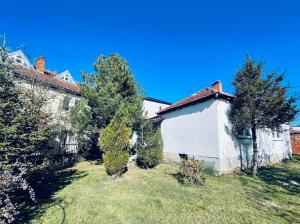 a house with a yard with trees in front of it at Podujeva - Home Sweet Home in Orllan