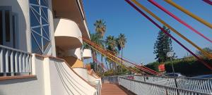 a balcony of a cruise ship with colorful ropes at Oasis House in Acireale