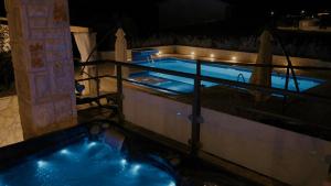 a swimming pool at night next to a building at Villa Kalista Istriana for 10 people with private pool & sea view in Gajana +49 photos
