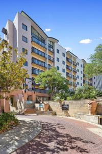 a large apartment building with a walkway in front of it at 309 Secret City Sanctuary Prkingpoolview in Perth
