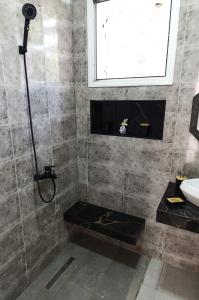 a bathroom with a shower with a sink and a window at La Marsa charming house Marsa in Tunis