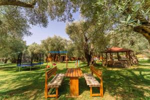a park with a picnic table and a playground at Apartments Aura in Utjeha