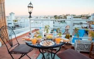 a tray of food on a table on a balcony at Riad KASBAH in Tangier