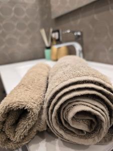 a pile of towels sitting on top of a sink at Mare e Relax in Mola di Bari +25 photos