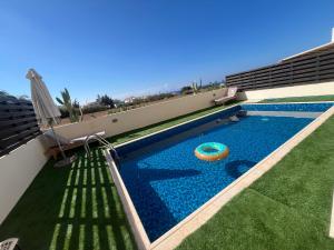 a swimming pool with a frisbee in the middle at Dene Hollow kapparis in Paralimni