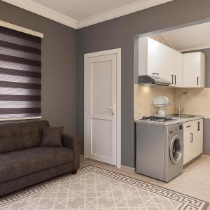 un soggiorno con divano e lavatrice di Warm Welcome a İvanovka