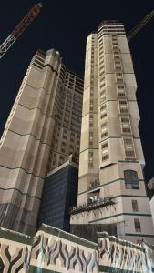 a tall building with a crane in front of it at برج الجوار السكني أجياد المصافي Jiwar Tower Ajyad Al Masafi in Al Gharīth