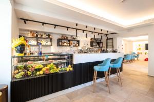 a bar in a restaurant with blue chairs at Hotel Palazzo Antonietta in San Marco di Castellabate