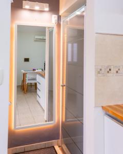 a sliding glass door leading into a kitchen with a table at Abu Rosa in Villa Elisa