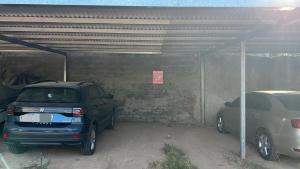 a garage with two cars parked in it at Abu Rosa in Villa Elisa