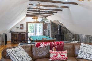 a living room with a couch and a pool table at 2 Homes Retreat Game Rooms & Fire Pit Winni in Moultonborough