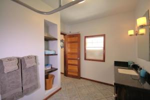 a bathroom with a sink and a refrigerator at Escape Away Belize Beach House in San Pedro +22 photos