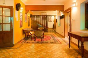 a hallway with chairs and a table in a house at Casa Memora 3BHK Private Pool Villa in Saligao +35 photos