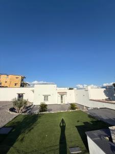 a shadow of a person standing on a lawn at Carotenuto Palace in Boscotrecase