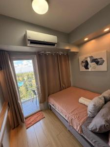 a small bedroom with a bed and a window at Tagaytay Wind Residences in Tagaytay +96 photos