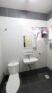 a bathroom with a toilet and a sink and a shower at Andalus Homestay in Jerantut +19 photos