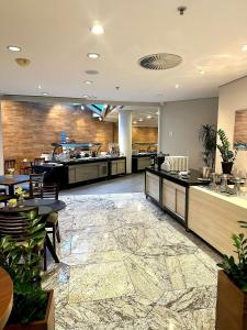 a restaurant with a lobby with tables and chairs at Flat 1638 on Ibirapuera Avenue in Moema - São Paulo in São Paulo +21 photos