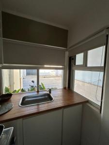 a kitchen with a sink and a window at Brisas paraiso in Concepción del Uruguay