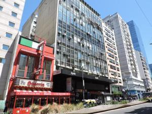 a large building in a city with tall buildings at Moderno departamento con garage para autos en el corazón de Buenos Aires in Buenos Aires