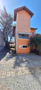 a house with a palm tree in front of it at Quarto individual in Mogi das Cruzes