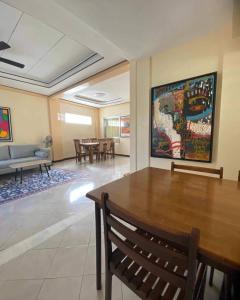 a living room with a table and a couch at Cozy 3br home entry to CWC, Pili Golf, Naga, Bicol in Pili