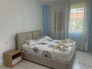 een slaapkamer met een bed met een teddybeer erop bij Villa 6C Sunny Nest in Draç