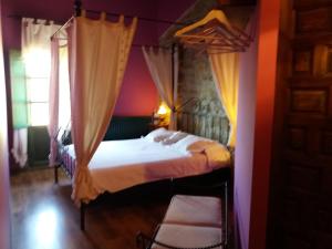 a bedroom with a bed with a canopy at Carpe Diem in Navaridas