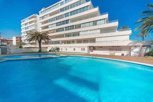 a large swimming pool in front of a building at SANTA BEACH in Roses