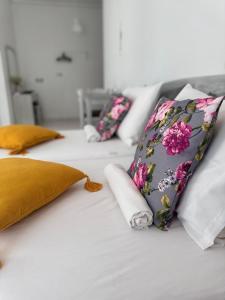 a row of pillows on top of a bed at ALEKA KOTSI ROOMS in Igoumenitsa