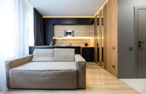 a living room with a couch and a kitchen at Nyvky Like Home - Файна Таун з басейном - Кв 3 in Kyiv +33 photos