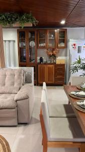 a living room with a couch and a refrigerator at Casa para alugar para a COP 30 in Belém +4 photos