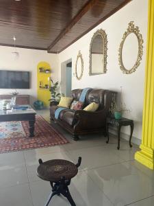 a living room with a leather couch and a table at La Mia casa in Gaborone