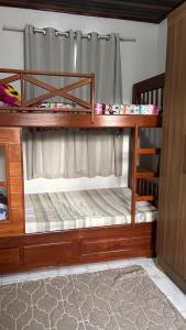 twolevel bunk beds in a room with a curtain at Casa para alugar para a COP 30 in Belém