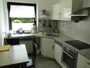 a kitchen with a sink and a counter top at 3 Sterne Gästehaus Zollerblick in Zimmern