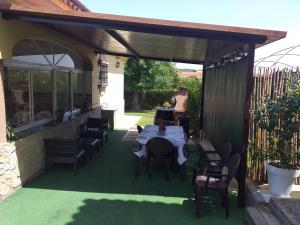 a patio with a table and chairs under awning at Casa La Laguneta in Arcos de la Frontera