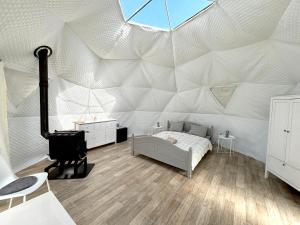 a room with a bed in a white tent at Bubble House glamping telk in Sõmeru +18 photos