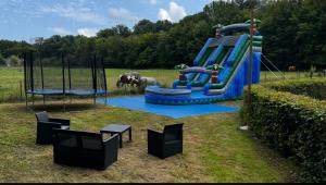 a playground with a water slide in a field at le Gite de illian in Saint-Michel