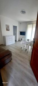 a large living room with a white table in it at appartamento Levi in Ravenna