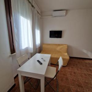 a living room with a white table and a couch at Appartamento King a Gattatico Centro in Praticello di Gattatico +6 photos