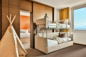 a bedroom with two bunk beds and a window at InterContinental Genève by IHG in Geneva