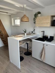 a kitchen with a sink and a counter top at ZeNova Vendégház in Szekszárd +1 photo