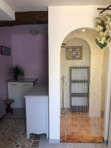 a kitchen with a gate in the middle of a room at House 2 people in Castaignos-Souslens