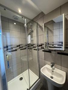 a bathroom with a shower and a sink at The Marlborough Sea View Holiday Apartments in Scarborough